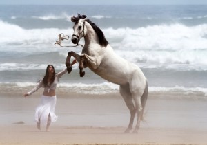 woman and horse on beach